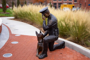 kneeling k9 officer with dog